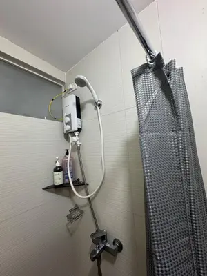 a shower in a bathroom with a shower curtain at Sentinel Residences 1 bedroom partition in Manila