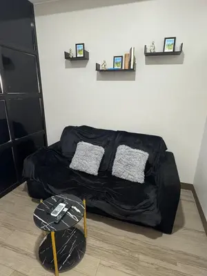 a bed with a black cover in a room at Sentinel Residences 1 bedroom partition in Manila