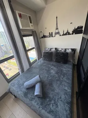 a bedroom with a bed with a statue of the eiffel tower at Sentinel Residences 1 bedroom partition in Manila