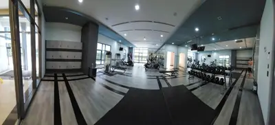 a gym with rows of exercise equipment in a building at 14e BGC Unit 3 mins Walk to The Venice Grand Canal Mall Pet Friendly in Manila