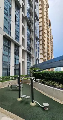 a building with a table and chairs in front of it at 14e BGC Unit 3 mins Walk to The Venice Grand Canal Mall Pet Friendly in Manila
