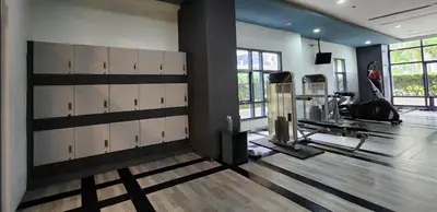 a fitness room with a gym with a treadmill at 14e BGC Unit 3 mins Walk to The Venice Grand Canal Mall Pet Friendly in Manila