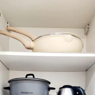 a pot and a pan on a shelf in a refrigerator at 14e BGC Unit 3 mins Walk to The Venice Grand Canal Mall Pet Friendly in Manila