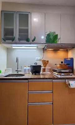 a kitchen with a sink and a counter top at 2 Unique Side-by-Side Studios Vibrant & Zen at Viceroy BGC in Manila