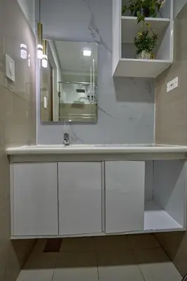 a bathroom with a white sink and a mirror at Shore 2 Reminisce in Manila
