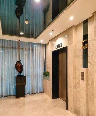 a lobby with a door and a vase on a table at Shore 2 Reminisce in Manila