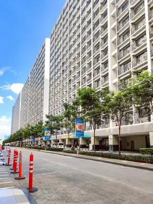 a large building with orange cones in front of a street at Shore 2 Reminisce in Manila