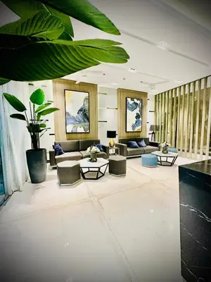 a large living room with couches and tables at Addison Place at SMDC Charm in Manila