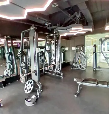 a gym with several tread machines in a room at 1BR in Makati Prime Location in Manila