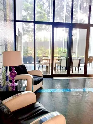 a living room with a couch and chairs and a table at 1BR in Makati Prime Location in Manila