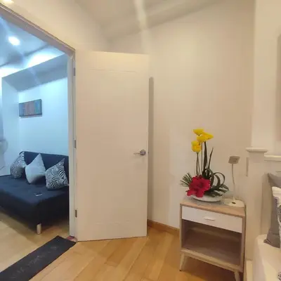 a living room with a blue couch and a table at 1BR in Makati Prime Location in Manila