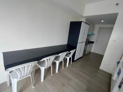a room with a counter with chairs and a refrigerator at Casa Relajante at Recto Manila in Manila