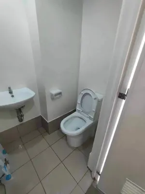 a bathroom with a white toilet and a sink at Casa Relajante at Recto Manila in Manila