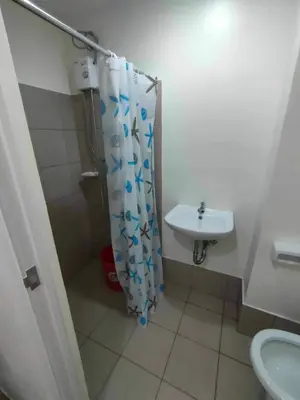 a bathroom with a shower curtain and a sink at Casa Relajante at Recto Manila in Manila