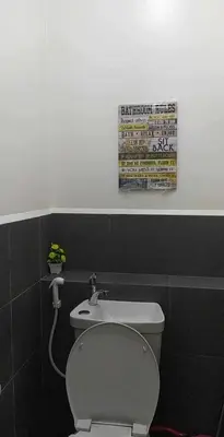 a bathroom with a white toilet and a sink at Deca Cubao Tower Budget Condo by Ashti in Manila