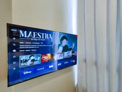 a flat screen tv hanging on a wall at 1BR Condotel Suite at Sunshine100 City Plaza #SS01-1 in Manila