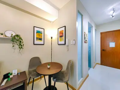a room with a table and chairs and a hallway at 1BR Condotel Suite at Sunshine100 City Plaza #SS01-1 in Manila