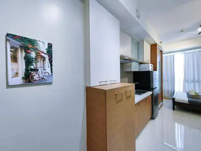 a kitchen with a wooden cabinet in a room at 1BR Condotel Suite at Sunshine100 City Plaza #SS01-1 in Manila