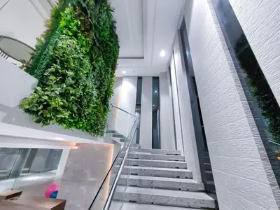 a staircase in a building with a green wall at 1BR Condotel Suite at Sunshine100 City Plaza #SS01-1 in Manila