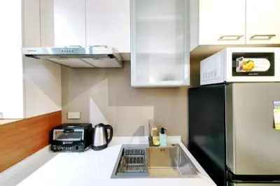a kitchen with a sink and a black refrigerator at 1BR Condotel Suite at Sunshine100 City Plaza #SS01-1 in Manila