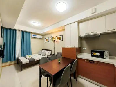 a living room with a table and a couch at 1BR Condotel Suite at Sunshine100 City Plaza #SS02-1 in Manila