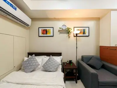 a bedroom with a bed and a couch at 1BR Condotel Suite at Sunshine100 City Plaza #SS02-1 in Manila