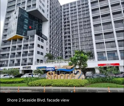 a group of tall buildings in a city at Affordable Stay in MOA in Manila