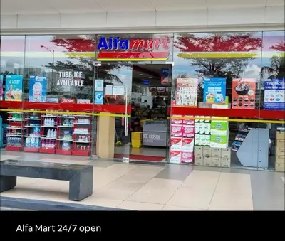 a store front of a store with a bench in front at Affordable Stay in MOA in Manila