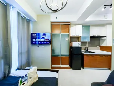 a small kitchen with a refrigerator and a counter at 1BR Condotel Suite at Sunshine100 City Plaza #SS03-1 in Manila