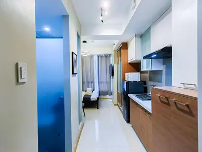 a kitchen with blue and white walls and a room at 1BR Condotel Suite at Sunshine100 City Plaza #SS03-1 in Manila