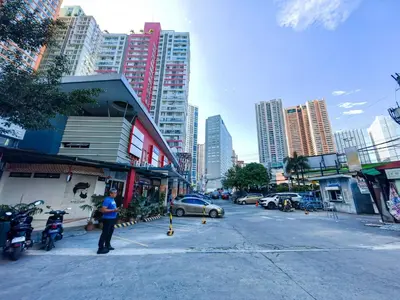 a person standing on a street in a city at 1BR Condotel Suite at Sunshine100 City Plaza #SS05-1 in Manila