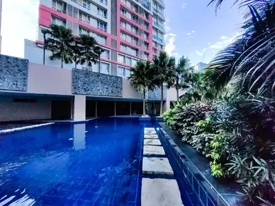 a swimming pool in front of a building at 1BR Condotel Suite at Sunshine100 City Plaza #SS05-1 in Manila