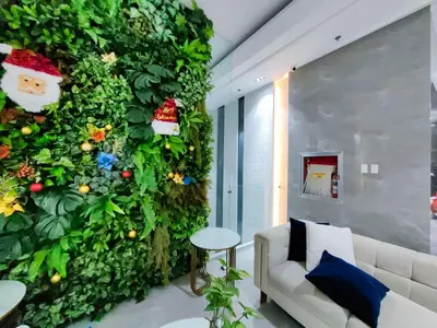 a living room with a green wall at 1BR Condotel Suite at Sunshine100 City Plaza #SS05-1 in Manila