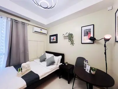 a small room with a bed and a table at 1BR Condotel Suite at Sunshine100 City Plaza #SS05-1 in Manila