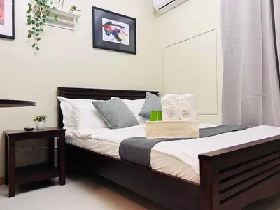 a bedroom with a bed with towels on it at 1BR Condotel Suite at Sunshine100 City Plaza #SS06-1 in Manila
