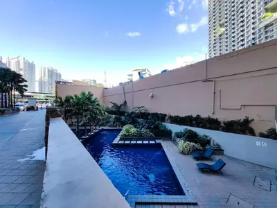 a swimming pool on the side of a building at 1BR Condotel Suite at Sunshine100 City Plaza #SS07-1 in Manila