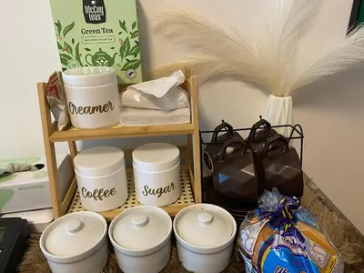 a shelf with a bunch of bowls and a bunch of bags at Azure staycation by scarlet suites in Manila
