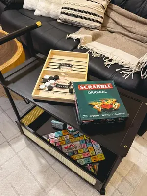 a coffee table with games on it next to a couch at Studio 12LVE in Manila