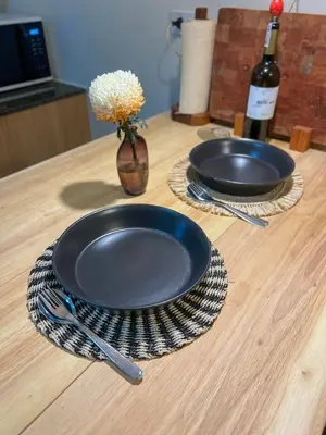 a table with two plates and a bottle of wine at Studio 12LVE in Manila