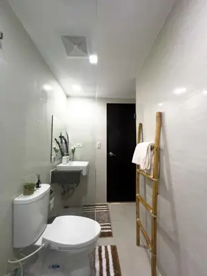 a bathroom with a white toilet and a sink at Studio 12LVE in Manila