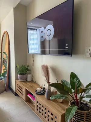 a living room with a flat screen tv on the wall at Studio 12LVE in Manila