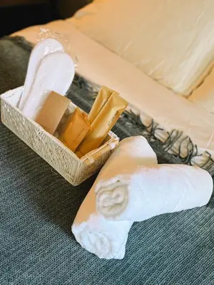 a box of soap and a towel on a bed at Studio 12LVE in Manila