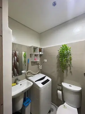 a bathroom with a toilet and a sink at Myras aesthetic unit in Manila