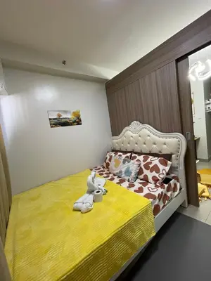 a bedroom with a bed with a stuffed animal on it at Myras aesthetic unit in Manila
