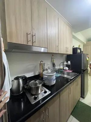 a kitchen with two pots and pans on a stove at Myras aesthetic unit in Manila