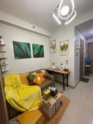 a living room with a couch and a table at Myras aesthetic unit in Manila