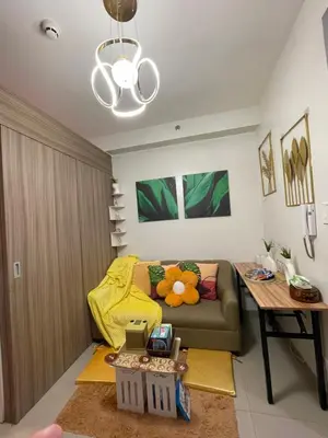 a living room with a couch and a table at Myras aesthetic unit in Manila