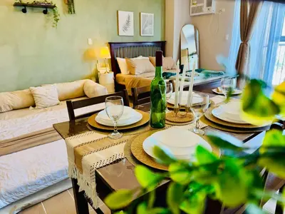 a living room with a table with plates and wine glasses at Venice IG-Worthy , Netlfix Getaway walking distance to Mall in Manila