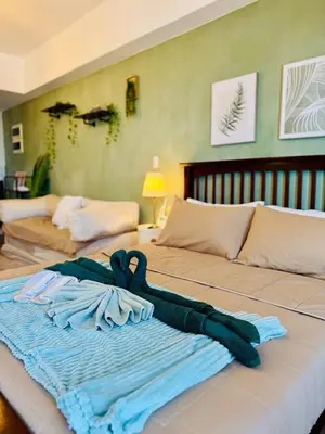 a bed with a towel on top of it at Venice IG-Worthy , Netlfix Getaway walking distance to Mall in Manila