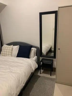 a bedroom with a bed and a mirror at Fame Tower 2 Luxury Queen with own Washer in Manila